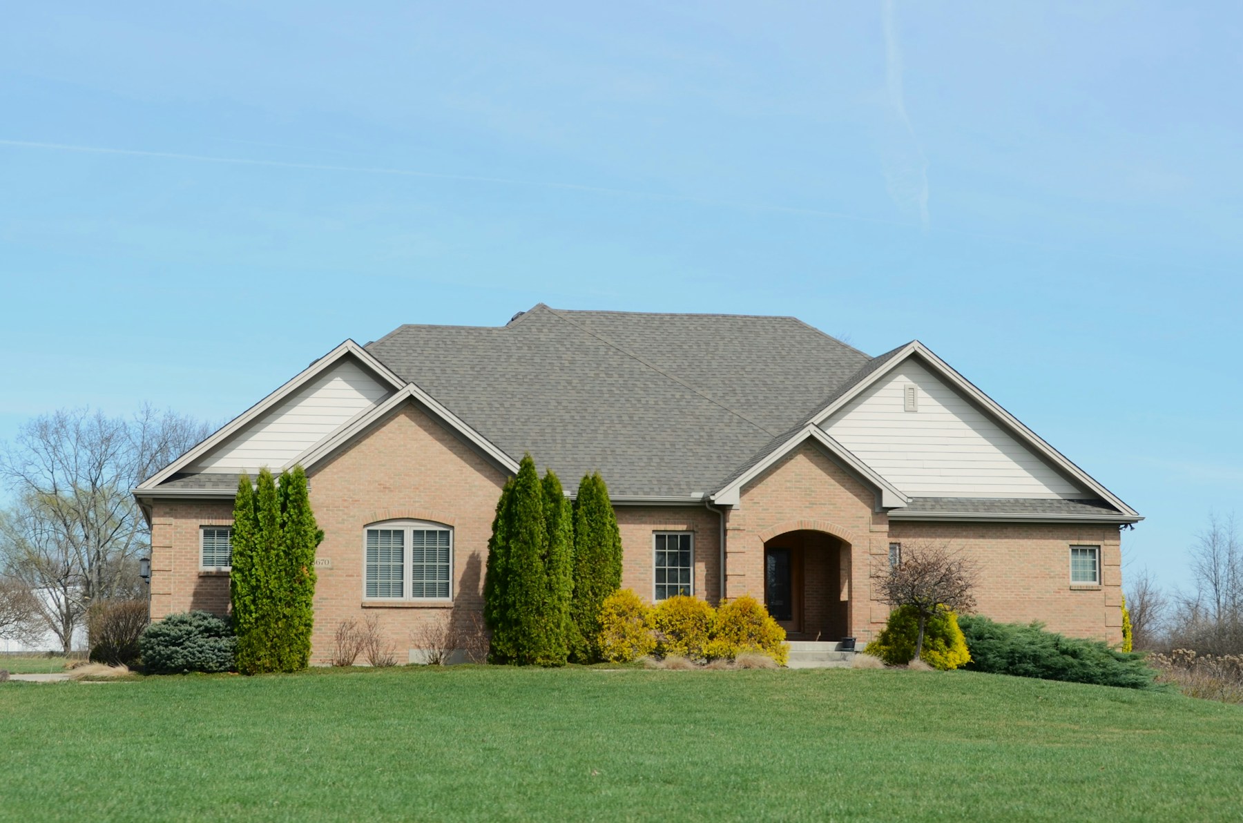 Detached Canadian home with a maintained front lawn